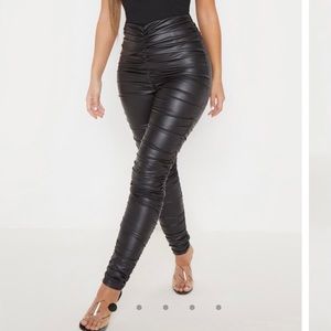 Black coated ruched side leggings